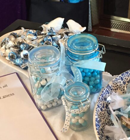 Clear jars lined up with blue candies and a gift bag in the background Olde Square Inn Mount Joy PA