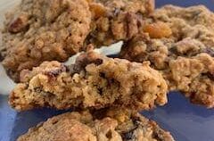 Cookies stacked, showing apricots, craisins, walnuts and pecans