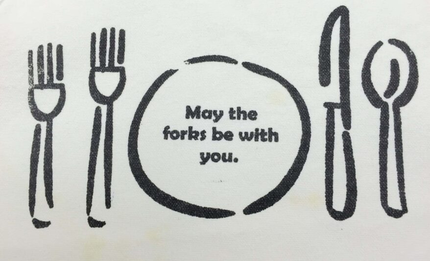 Black outline of a sketched table setting with the words 