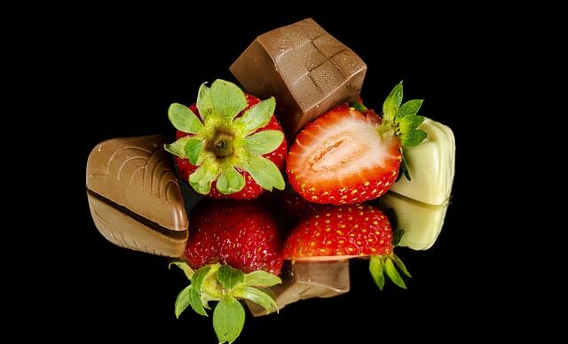 Strawberries and chocolate against a black background