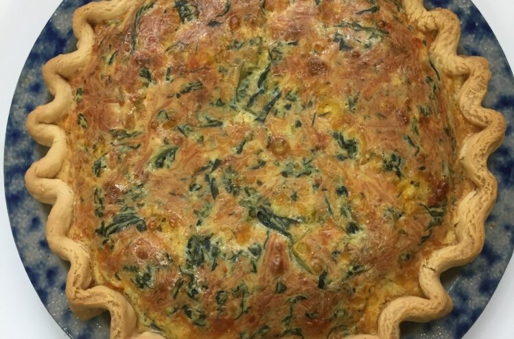 lightly browned spinache quiche in a pastry crust - overhead view
